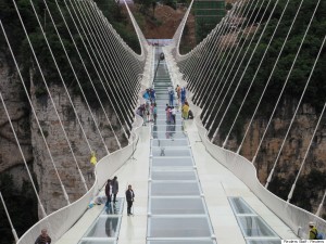 People wait for a safety test ceremony of a 430-meter-long glass-bottom bridge in Zhangjiajie